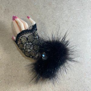 Hand shaped brooch with lace and fur